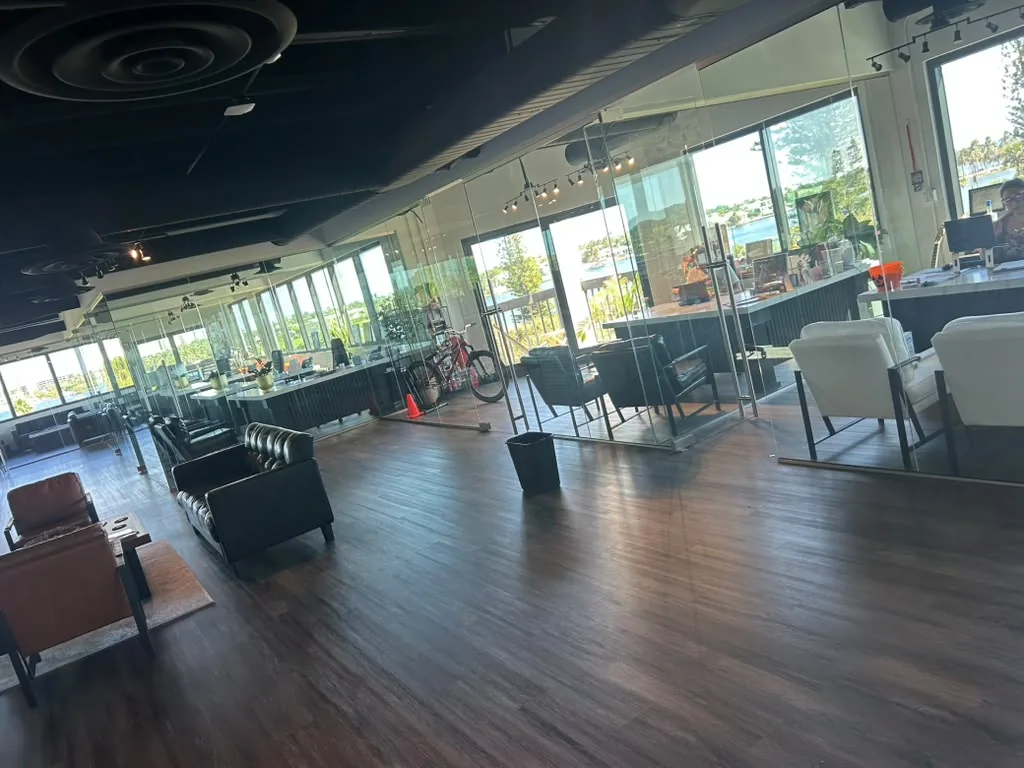 A commercial office Sunset Sparkle cleans, with glass walls and dark ceilings
